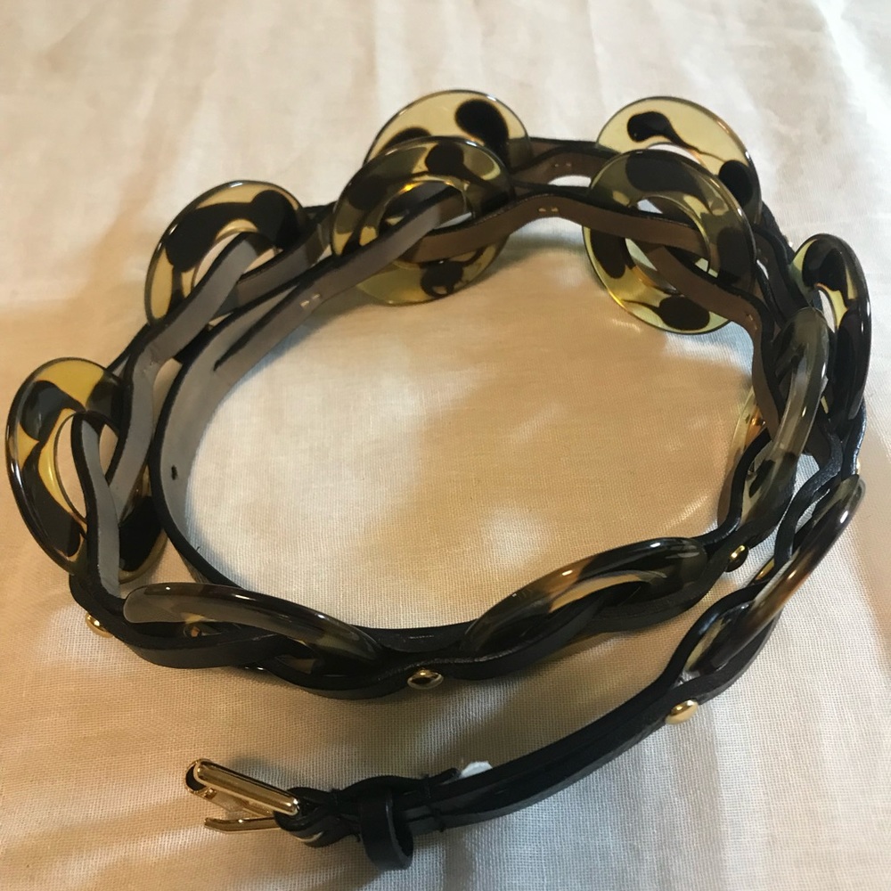 Leopard print resin circles intertwined with leather.